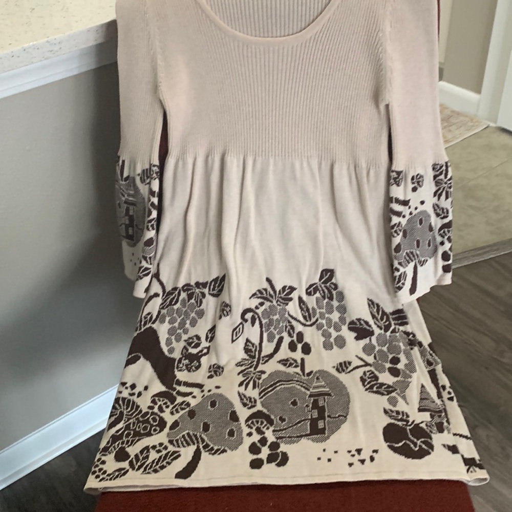 Empire cut, rounded low neckline with sweater ribbed knit on top.